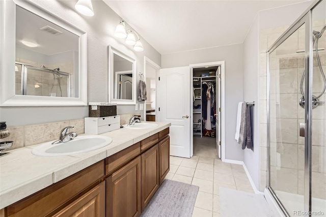 3744 Gypsum Ct, Superior, CO 80027 - bathroom featuring visible vents, a shower stall, a sink, and tile patterned flooring