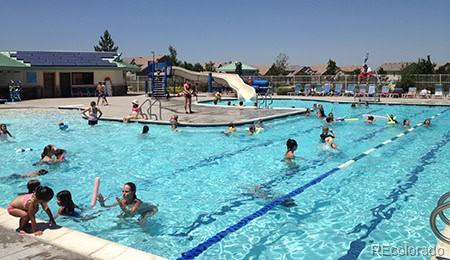 3744 Gypsum Ct, Superior, CO 80027 - community pool with a water slide and a patio area