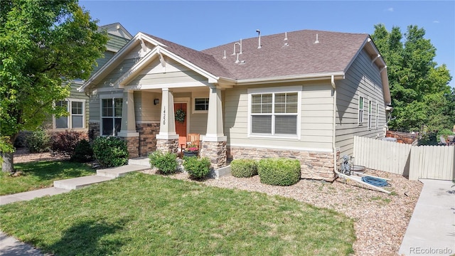 14230 Lakeview Ln, Broomfield, CO 80023 - craftsman house with a porch, stone siding, and a shingled roof