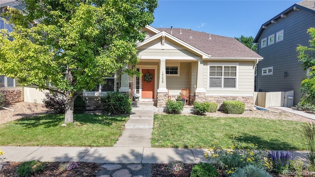 14230 Lakeview Ln, Broomfield, CO 80023 - view of front of property with a front lawn, stone siding, covered porch, and roof with shingles