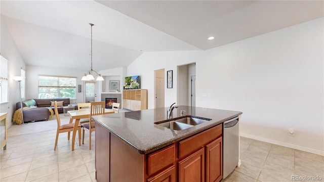 14230 Lakeview Ln, Broomfield, CO 80023 - kitchen with dishwasher, open floor plan, vaulted ceiling, a glass covered fireplace, and dark stone countertops