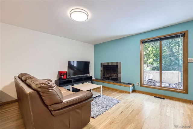 800 Illinois St Unit 1, Golden, CO 80401 - living room with wood finished floors, a tile fireplace, and baseboards