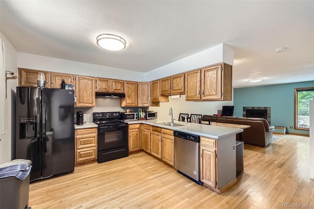 800 Illinois St Unit 1, Golden, CO 80401 - kitchen featuring black appliances, a sink, under cabinet range hood, and light wood-style floors