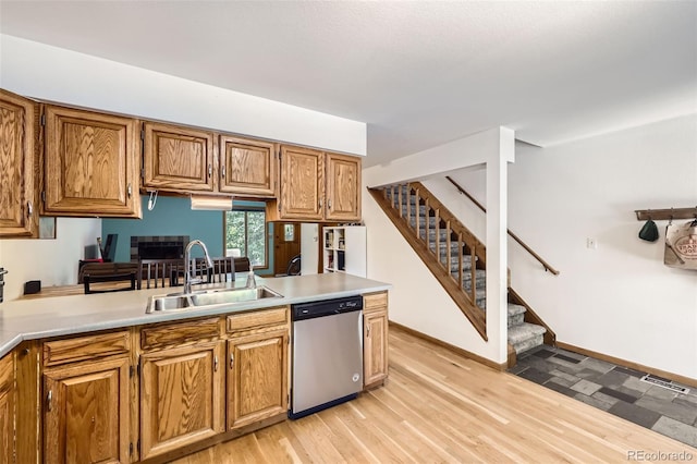 800 Illinois St Unit 1, Golden, CO 80401 - kitchen with stainless steel dishwasher, a sink, light countertops, and brown cabinets