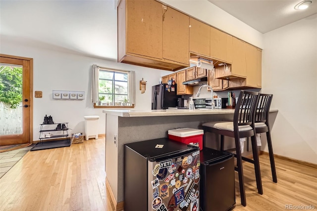 800 Illinois St Unit 1, Golden, CO 80401 - kitchen featuring freestanding refrigerator, light wood-style floors, under cabinet range hood, and healthy amount of natural light
