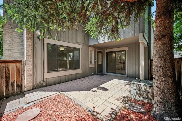1219 S Yosemite Way Unit 63, Denver, CO 80247 - doorway to property featuring a patio area