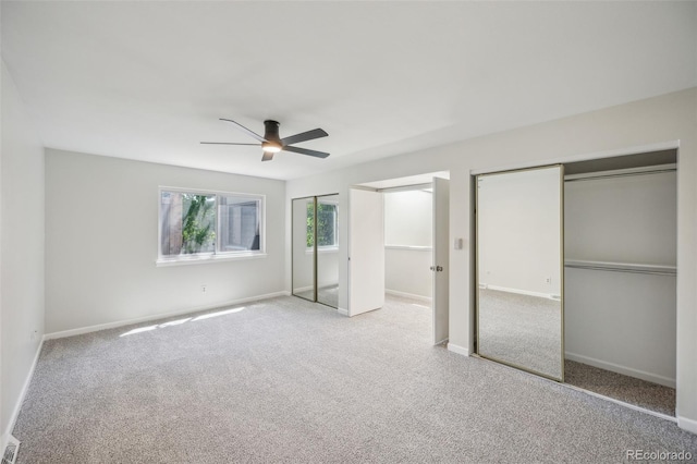 1219 S Yosemite Way Unit 63, Denver, CO 80247 - unfurnished bedroom featuring carpet flooring, baseboards, a ceiling fan, and multiple closets