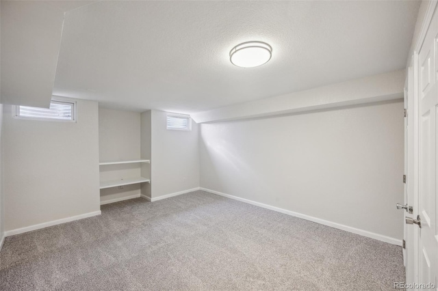 1219 S Yosemite Way Unit 63, Denver, CO 80247 - basement with carpet flooring, baseboards, and a textured ceiling