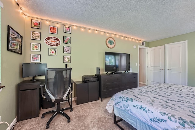 carpeted bedroom with a closet and a textured ceiling