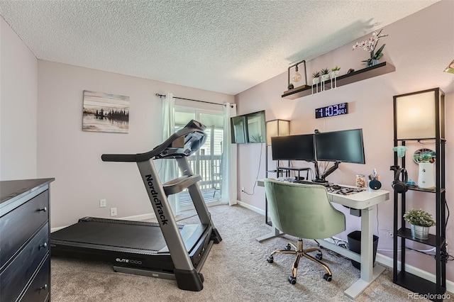 carpeted office space featuring a textured ceiling