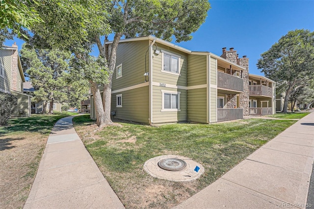 view of building exterior with an outdoor fire pit