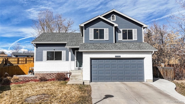 view of front of house featuring concrete driveway, brick siding, an attached garage, and fence