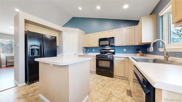 kitchen with a center island, light countertops, vaulted ceiling, a sink, and black appliances