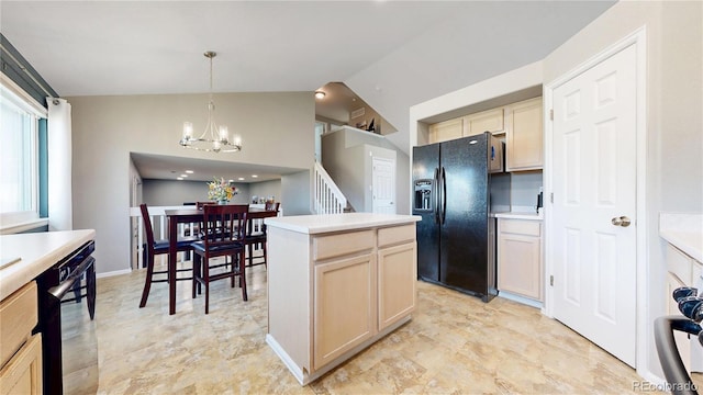 kitchen with lofted ceiling, a center island, light countertops, black appliances, and a notable chandelier