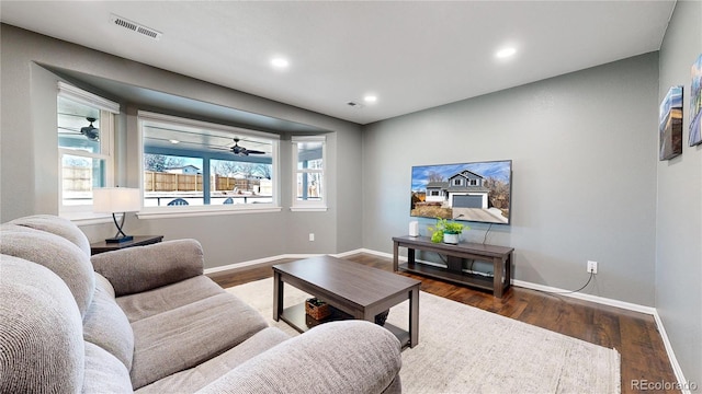 living area with recessed lighting, wood finished floors, visible vents, and baseboards