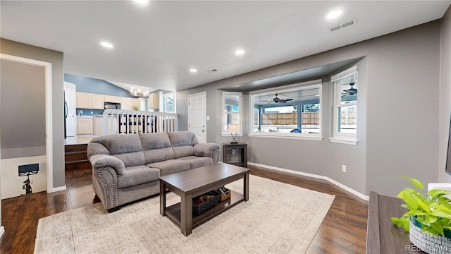 living room featuring baseboards, dark wood-type flooring, visible vents, and recessed lighting