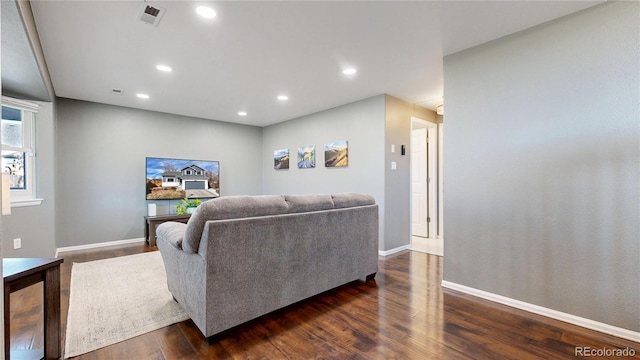 living room with recessed lighting, visible vents, dark wood finished floors, and baseboards