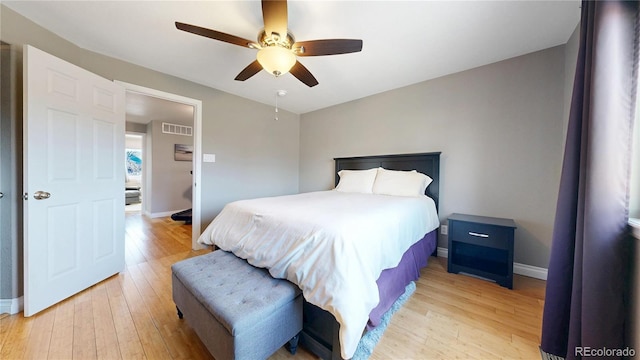 bedroom with light wood-type flooring, baseboards, and visible vents