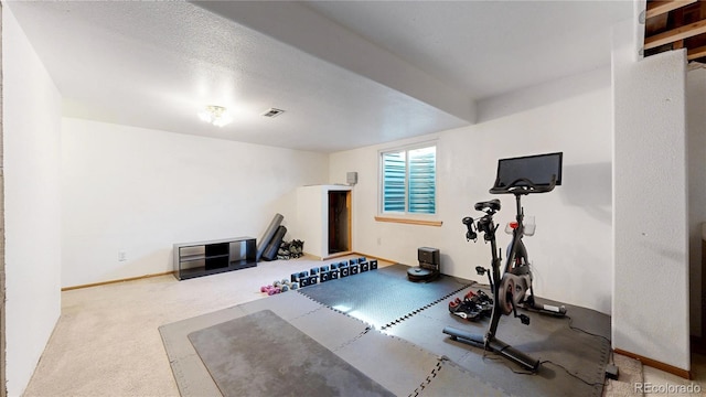 workout room featuring baseboards, visible vents, and carpet flooring