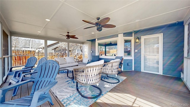 wooden terrace with fence, outdoor lounge area, and a ceiling fan