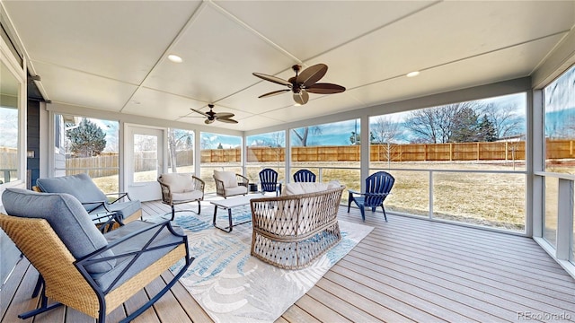 sunroom featuring a ceiling fan