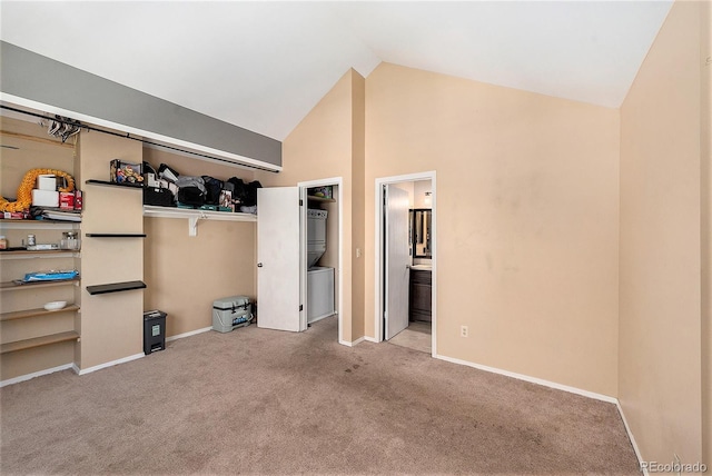 unfurnished bedroom featuring carpet flooring, baseboards, high vaulted ceiling, and connected bathroom