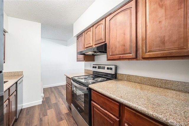 kitchen featuring light stone counters, dark wood-type flooring, stainless steel appliances, and a textured ceiling