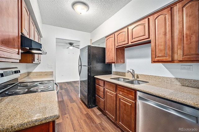 kitchen with dark wood-type flooring, sink, light stone counters, ceiling fan, and stainless steel appliances