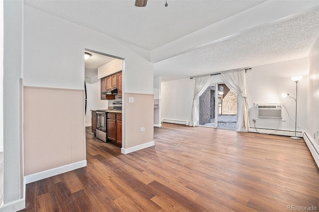 unfurnished living room featuring wood-type flooring, a wall unit AC, a textured ceiling, and a baseboard radiator