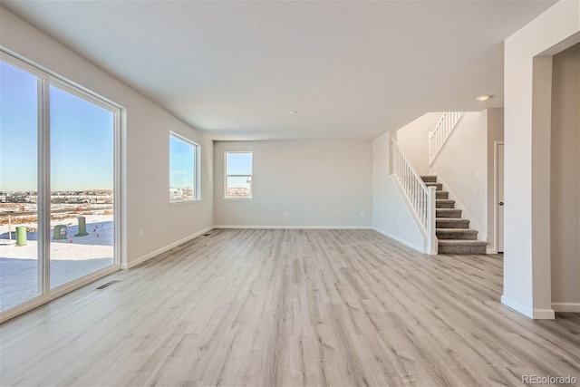 unfurnished living room featuring light wood-type flooring