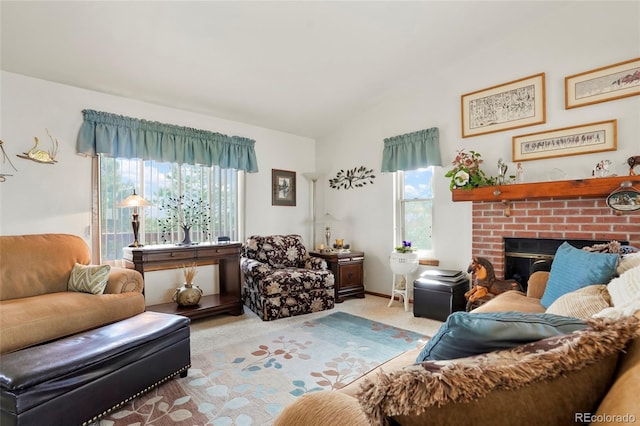 carpeted living room featuring a fireplace and vaulted ceiling