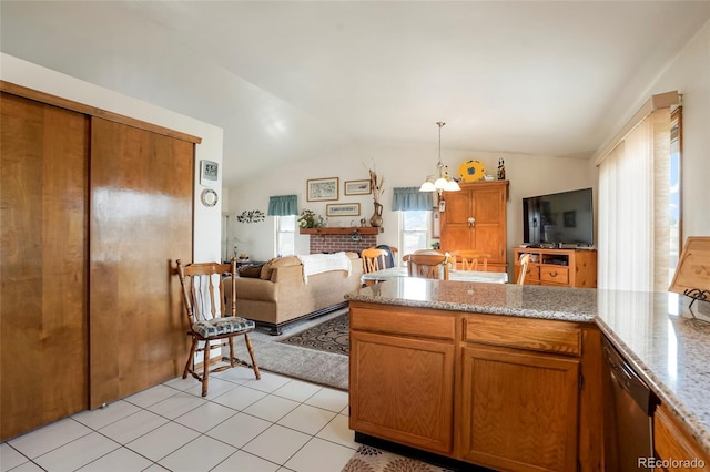 kitchen with light stone countertops, lofted ceiling, hanging light fixtures, and an inviting chandelier