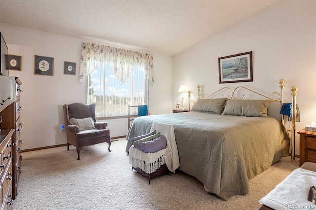 bedroom featuring light carpet, a textured ceiling, and lofted ceiling