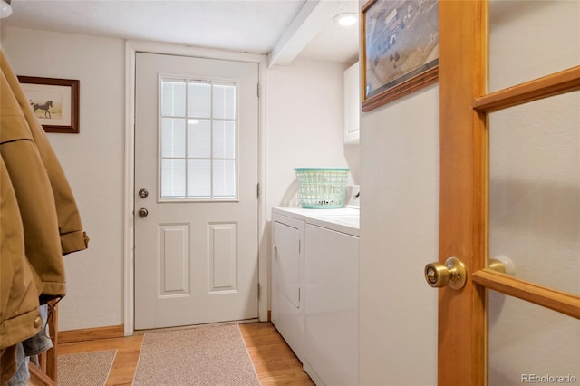 washroom with cabinets, separate washer and dryer, and light hardwood / wood-style flooring