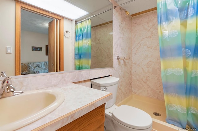 bathroom featuring curtained shower, vanity, and toilet