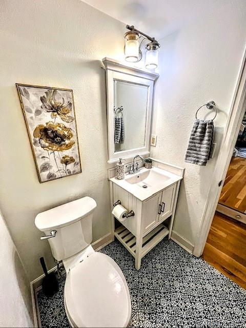 bathroom featuring toilet and vanity