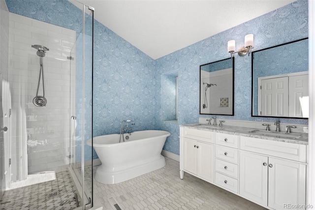 bathroom with tile patterned flooring, independent shower and bath, and vanity