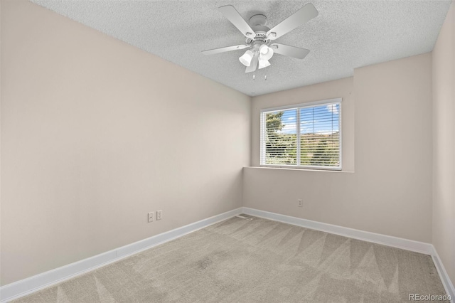 carpeted empty room featuring a textured ceiling and ceiling fan