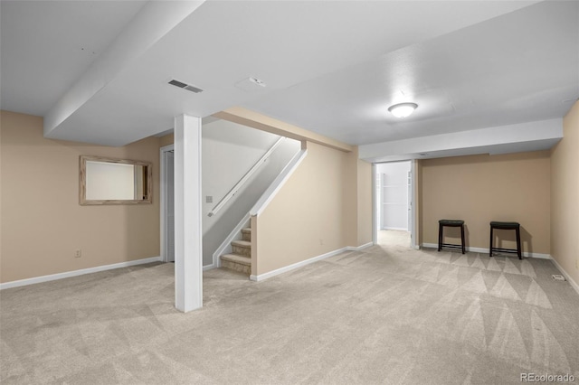 basement featuring light colored carpet