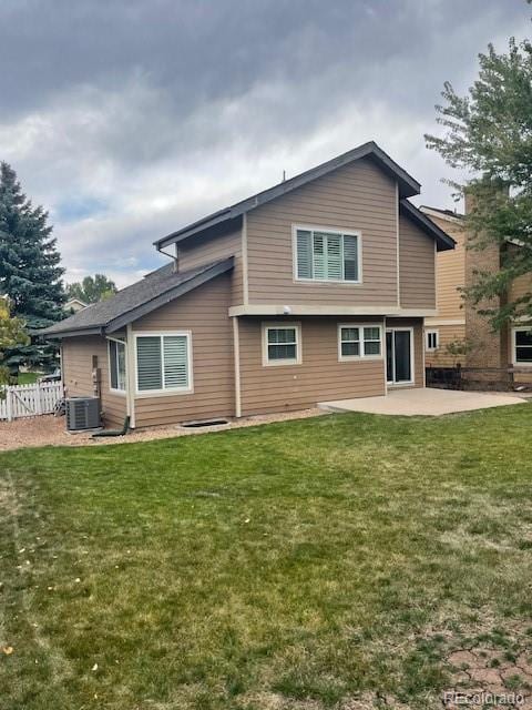 back of house with a patio and a yard