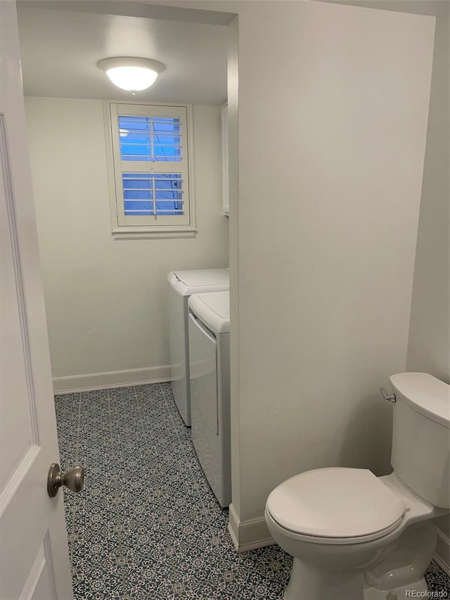 bathroom featuring toilet and washer and clothes dryer