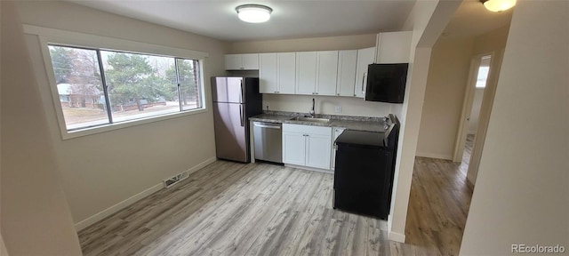 8001 Lowell Blvd, Westminster, CO 80031 - kitchen featuring a sink, visible vents, baseboards, and appliances with stainless steel finishes