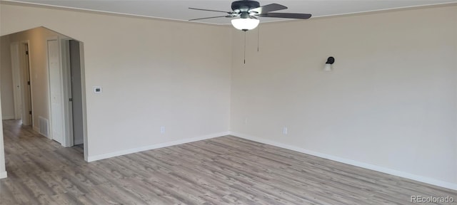 8001 Lowell Blvd, Westminster, CO 80031 - spare room featuring light wood-type flooring, visible vents, a ceiling fan, arched walkways, and baseboards