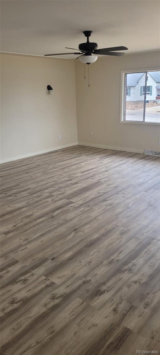 8001 Lowell Blvd, Westminster, CO 80031 - spare room featuring a ceiling fan, wood finished floors, and baseboards