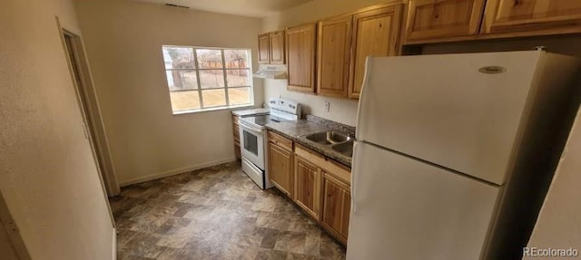 8001 Lowell Blvd, Westminster, CO 80031 - kitchen with white appliances, baseboards, a sink, under cabinet range hood, and dark countertops