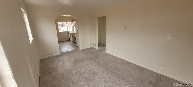 8001 Lowell Blvd, Westminster, CO 80031 - empty room with arched walkways, carpet flooring, baseboards, and visible vents