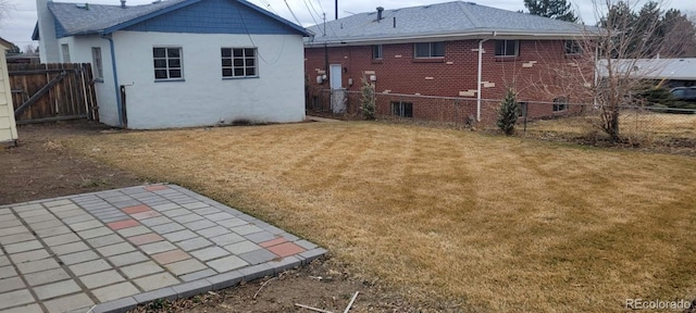8001 Lowell Blvd, Westminster, CO 80031 - back of property featuring a patio area, brick siding, a yard, and fence
