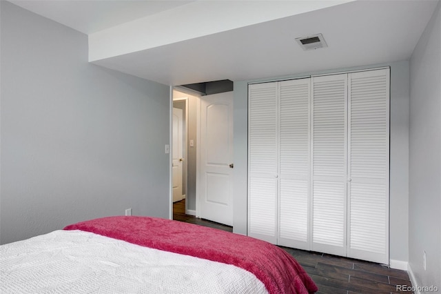 11338 Donley Dr, Parker, CO 80138 - bedroom featuring dark wood-style floors, a closet, and baseboards