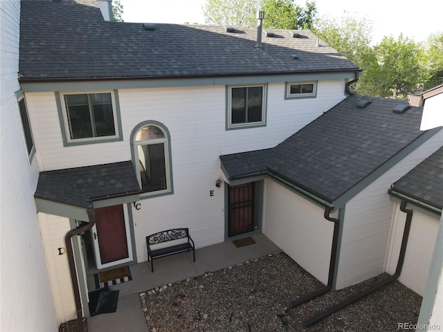 view of front of home featuring roof with shingles and a chimney