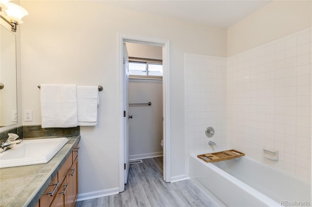 full bathroom with wood finished floors, toilet, vanity, and baseboards